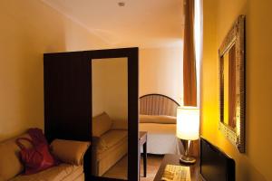 Postel nebo postele na pokoji v ubytování Hotel Novecento