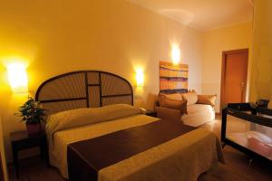 Postel nebo postele na pokoji v ubytování Hotel Novecento