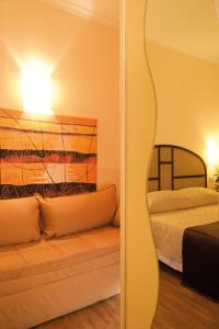 Postel nebo postele na pokoji v ubytování Hotel Novecento