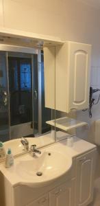a bathroom with a white sink and a mirror at Ferienwohnung Quednau in Grafenau