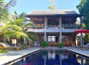 a house with a swimming pool in front of a house at Ping Pool Villa 1 in Mae Rim