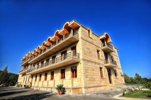 a building with balconies on the side of it at Hirkan Park Hotel in Lankaran