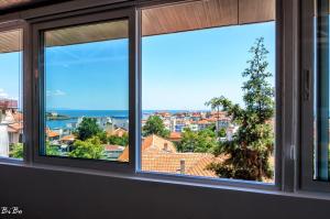 a window with a view of a city at Dom Mladenovi in Sozopol