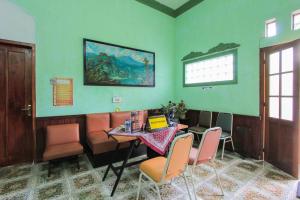 una sala da pranzo con tavolo e sedie in una stanza di SPOT ON 2490 Griya Kencana Homestay a Banyuwangi