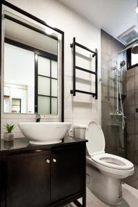 a bathroom with a sink and a toilet at Livinn91 Hotel in Bangkok