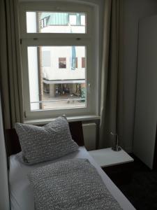 a bedroom with a window and a bed with a pillow at Ferienwohnung Speyer in Speyer