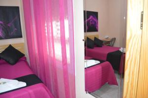 Postel nebo postele na pokoji v ubytování Hostal Carrizo