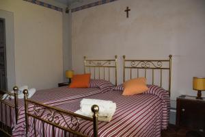 a bedroom with a bed with a cross on the wall at Borgo Vecchio in Montalcino