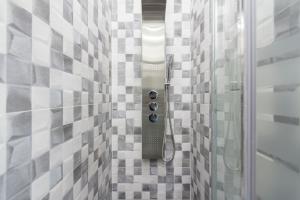 a shower in a bathroom with a tile wall at Gran Vía Apartment in Madrid +47 photos