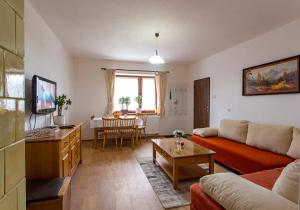 a living room with a couch and a table at Sofia Veterník C in Kremnica