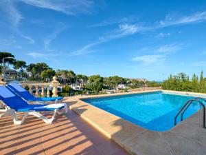 a deck with a pool and chairs next to a swimming pool at Holiday Home Cap Marti by Interhome in Balcon del Mar