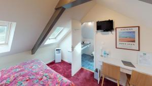 a hotel room with a bed and a desk at Hotel de charme Les Mimosas in Pont-Aven