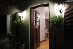 a hallway with a door and two potted plants at Abiento Guesthouse in Bloemfontein