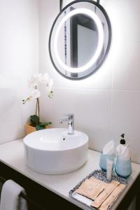 a bathroom with a white sink and a mirror at Indie Hotel Kuala Lumpur in Kuala Lumpur