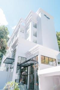 a white building with glass windows at Indie Hotel Kuala Lumpur in Kuala Lumpur