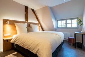 a bedroom with a large bed and a window at coucou hotel & kuckucks-stube (Titisee) in Titisee-Neustadt