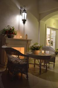 a living room with two chairs and a table with candles at Zielone Zacisze in Murzynowo Kościelne