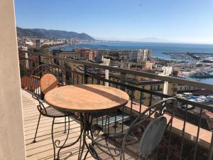 a table and chairs on a balcony with a view of the city at Casa sul mare in Salerno