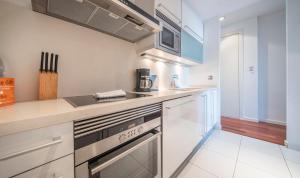 a kitchen with a sink and a stove top oven at You Stylish City Center Apartments in Barcelona