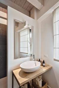 a bathroom with a white sink and a mirror at Trevisohome BOTTENIGA in Treviso