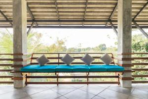 a bench on the porch of a house with a view at Ping Pool Villa 2 in Mae Rim