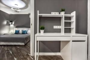 a bedroom with a white desk and a bunk bed at Grey Cardinal Apartment SUTKI LIFE in Tolyatti