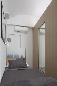 A bed or beds in a room at Genova Suite Art