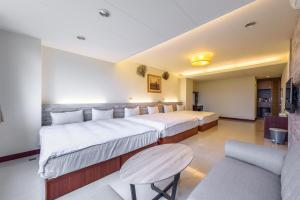 Postel nebo postele na pokoji v ubytování Yunlin Gukeng Da-Hu Villa B&B