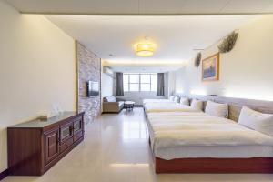 Postel nebo postele na pokoji v ubytování Yunlin Gukeng Da-Hu Villa B&B