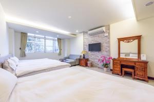 Postel nebo postele na pokoji v ubytování Yunlin Gukeng Da-Hu Villa B&B