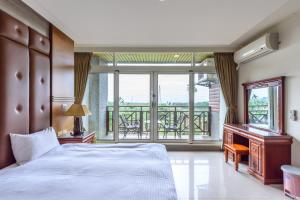 Postel nebo postele na pokoji v ubytování Yunlin Gukeng Da-Hu Villa B&B