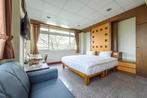 Postel nebo postele na pokoji v ubytování Yunlin Gukeng Da-Hu Villa B&B