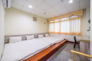 Postel nebo postele na pokoji v ubytování Yunlin Gukeng Da-Hu Villa B&B