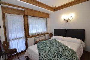 Krevet ili kreveti u jedinici u okviru objekta Punta Nera: appartamento con giardino e WIFI