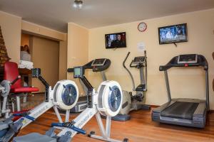 a gym with several exercise bikes and a tv at Willa Bryza in Gdynia