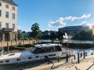 a boat is docked at a dock in a city at Holiday Inn Express - Mülheim - Ruhr by IHG in Mülheim an der Ruhr