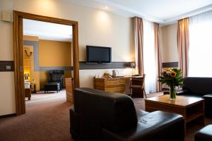 a living room filled with furniture and a tv at Art Hotel William in Bratislava