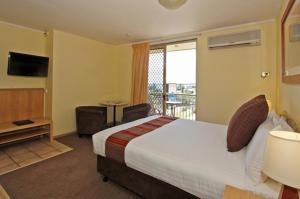 a hotel room with a bed and a balcony at Ocean View Motel in Perth