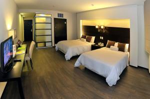 Rúm í herbergi á Unipark by Oro Verde Hotels