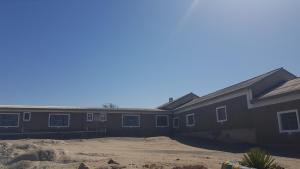 a house in the middle of a construction site at Prospectors Inn in Lüderitz