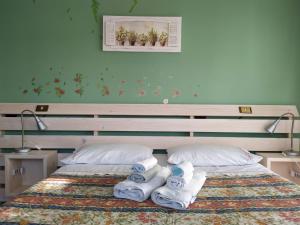 a bedroom with a bed with towels on it at B&B La Casa di Angelica in Roseto degli Abruzzi