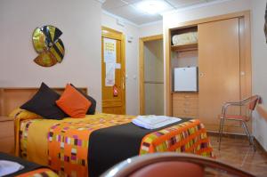 Postel nebo postele na pokoji v ubytování Hostal Carrizo