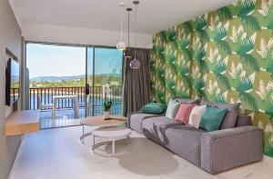 a living room with a couch and a table at Skiathos Palace Hotel in Koukounaries