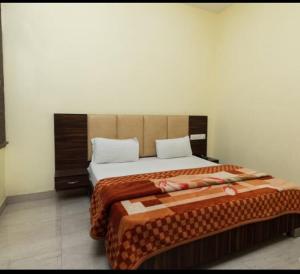 a bedroom with a large bed in a room at Hotel M City in Amritsar