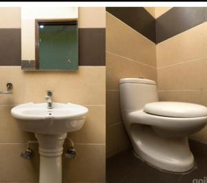 a bathroom with a toilet and a sink at Hotel M City in Amritsar