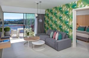 a living room with a couch and a table at Skiathos Palace Hotel in Koukounaries