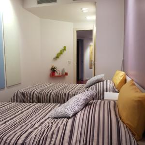 a bedroom with two beds with pillows at apartment luxe MMR in Barcelona