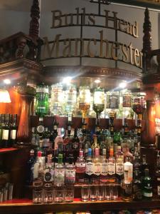 a bar with a bunch of bottles of alcohol at The Bulls Head Hotel in Manchester