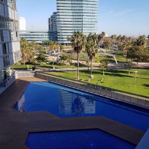 a swimming pool with a view of a city at apartment luxe MMR in Barcelona