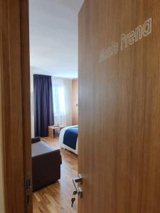 a door to a room with a bed and a bedroom at Hotel Miramonti in Castel del Monte